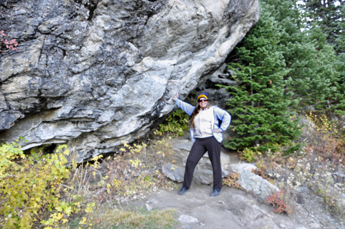 Karen Duquette by a big boulder alongside the paved trail